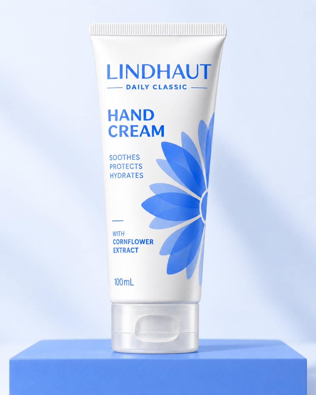 LINDHAUT Daily Classic hand cream, 100 mL tube standing on a cornflower-blue block